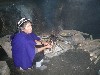 Indigenous woman by her fireplace