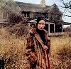 Little Edie in front of Grey Gardens.