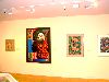 A wall of paintings and graphic designs.