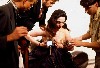 Technicians assisting Moorman with Paik&rsquo;s "TV Bra."