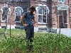 The artist A. Jacob Galle in a still from a video of creating a garden in front of an ersatz mansion.