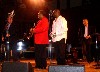 Jon Faddis in a red shirt with Sean Jones to his right.
