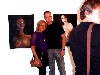 Christine and Mate posing in front of his paintings.