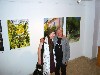 Lyudmila and Kalman posing in front of her paintings.