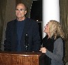 Carole King looking up at Taylor standing tall.