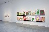 A wall of small paintings by Mike Kelly