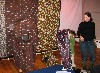 A Mom looks on as the kids try on camouflage outfits.