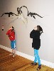 Kids playing under a relief sculpture in the exhibition.