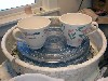 Cups by Megan Hart, placed in a potter&rsquo;s wheel.