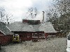 Steam billowing out of the roof of a sugar house in full swing.