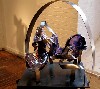 Poured glass under a steel arc.
