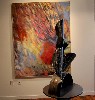 Painting and sculpture creating an abstract dialogue.