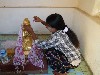 Applying gold leaf to Buddha statue