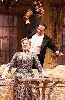 The impresario played by Tony Shaloub with his lead donor, Julia, created by Brooke Adams