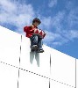 The drummer boy hovers on the roof edge.