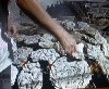 Metal strips and dried cow dung are placed over the mound of pots.
