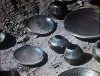 Removing the finished pots that have been transformed from red to black.