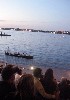 Passengers watch as life boat approaches then glides away with remaining musicians.