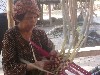 Basket weaver wearing traditional krama