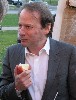 Adam taking a bite out of an apple.