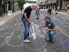 Arts leader, Phil Sellers (kneeling), working on Sidewalk&rsquo;s project last summer on Holden Street, is the force behind bringing the artist&rsquo;s project to Mass MoCA.