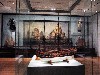 A display of marine paintings and ship models.
