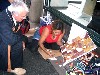 Jean-Marie is watching Cherie working on a painting. Ph: Roumengous