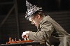 Kevin Burdette as Death plays chess.