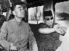 You will notice that Braun as Chou always hold his right hand this way.  One of the many details Nixon in China offers up.