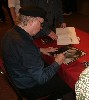 Tom, Now &Then. Tom autographs the LP jacket from his first Elektra album for a fan...