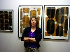 Sarah in front of ink paintings.