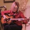 ...deftly finger-picking the melody as if it all came to her naturally. - photo by Mark Peters