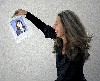 Carole Freeman, holding up a participant's portrait, is just delighted.