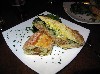 The delicious Cuban sandwich served with greens.