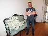  Clint Neufeld with a porcelain motor on a Victorian couch.