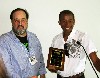 Board member Bill Hirschman, left, presents an award to Darren Canady.