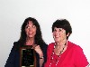 Caridad Svich receiving an award from Barbara Bannon.