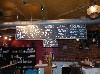 The blackboard menu is suspended over the bar.