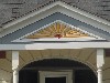 Stylized Sunburst Ornamentation over Porch Door Entrance and Front Windows.