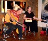 Fran on guitar while Lisa plays cigar box dulcimer.