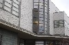 Geometric patterning with concrete, bricks, window mullions, building sections and  glass blocks with angles and curves.