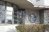 Front Entrance detail with curving canopy and elegant round window.