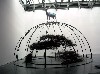 A deer is perched on top of a Merz sculpture.
