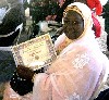 Ndeye Mbow with an A3D award for her charitable and educational work.